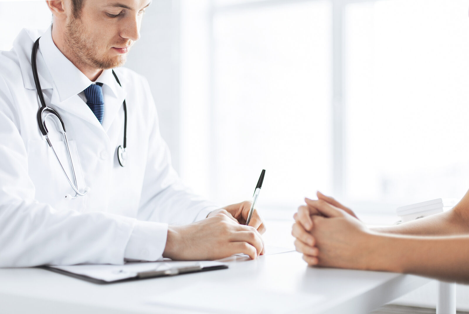 A clinician consulting with a patient